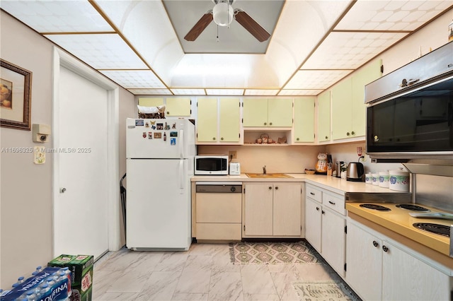 kitchen with ceiling fan, white appliances, a sink, marble finish floor, and light countertops