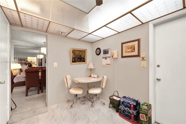 dining area featuring marble finish floor, visible vents, and baseboards