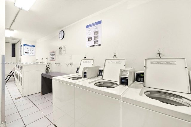 shared laundry area with light tile patterned floors and washer and clothes dryer