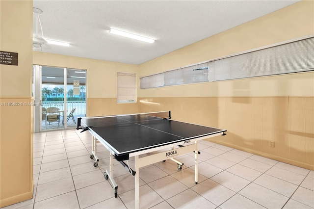 recreation room with light tile patterned flooring and a textured ceiling