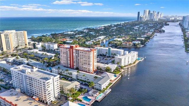 drone / aerial view featuring a water view and a view of city