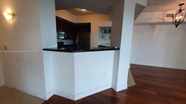 kitchen with appliances with stainless steel finishes and dark wood-type flooring