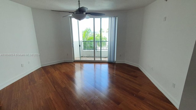 spare room with ceiling fan, dark hardwood / wood-style flooring, and a textured ceiling