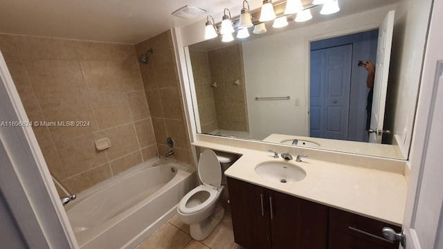 full bathroom with vanity, tiled shower / bath combo, tile patterned floors, and toilet