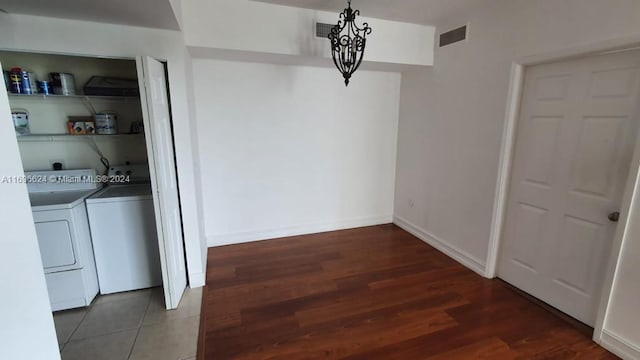 washroom featuring dark hardwood / wood-style floors and washer and clothes dryer