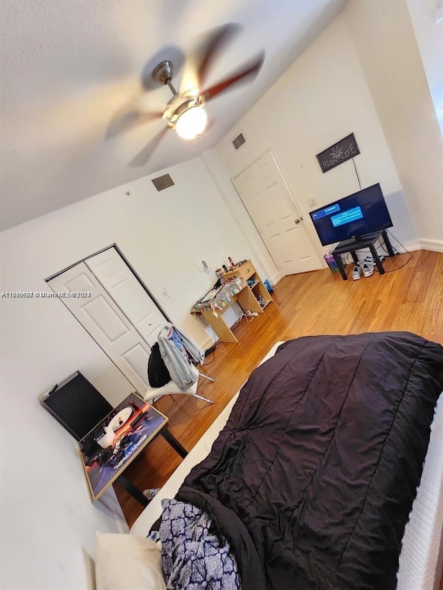 bedroom featuring hardwood / wood-style floors, ceiling fan, and lofted ceiling