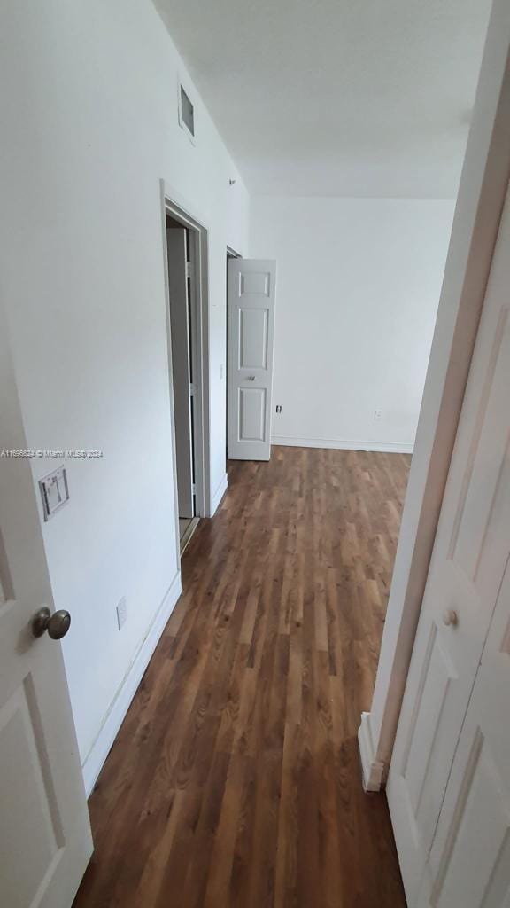 hall with dark wood-type flooring