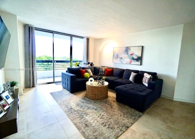 living room with tile patterned floors, floor to ceiling windows, and a textured ceiling