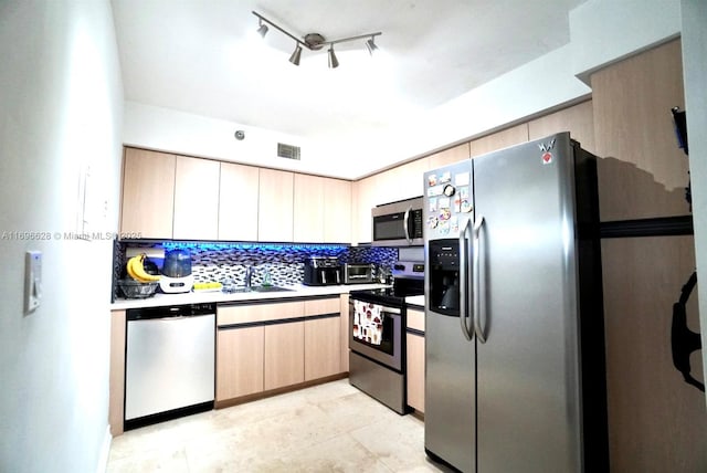 kitchen featuring tasteful backsplash, sink, stainless steel appliances, and light brown cabinets