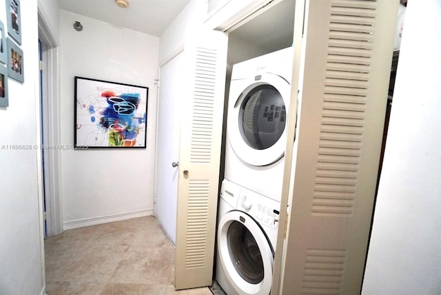 clothes washing area featuring stacked washer / dryer