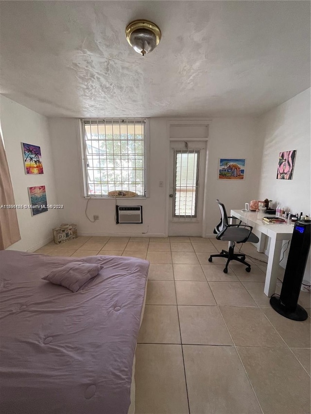 tiled bedroom with a textured ceiling and an AC wall unit