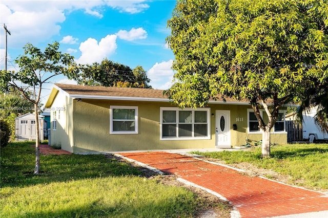 view of front of property with a front yard and stucco siding