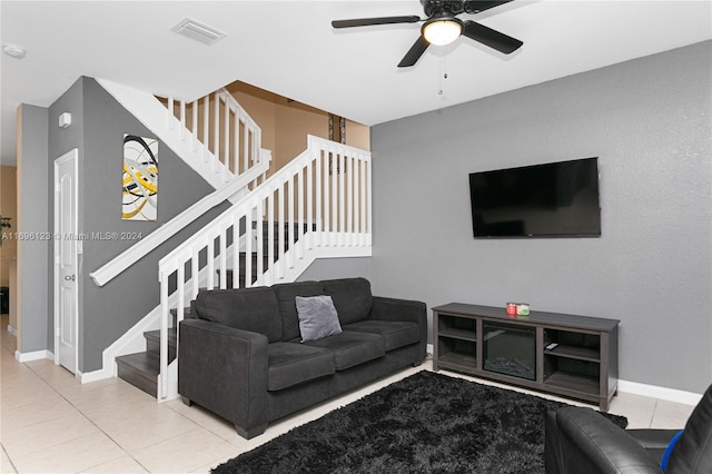 living room with tile patterned floors and ceiling fan