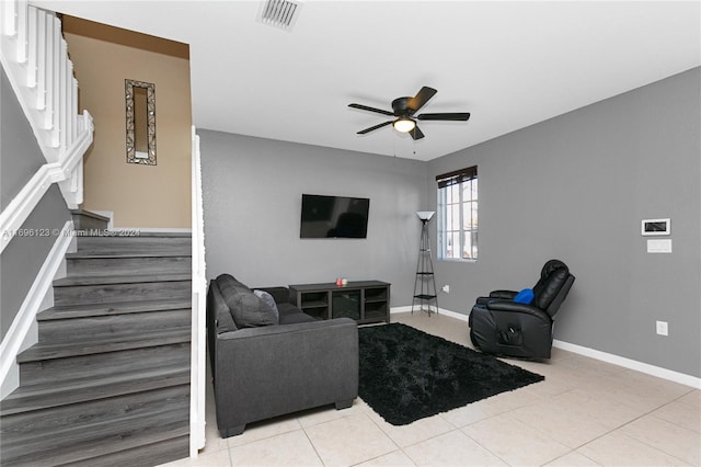 tiled living room with ceiling fan