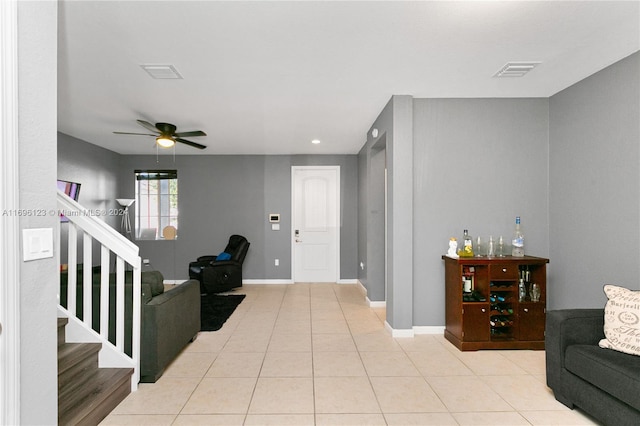 living room with ceiling fan and light tile patterned floors