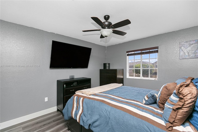 bedroom with ceiling fan and dark wood-type flooring