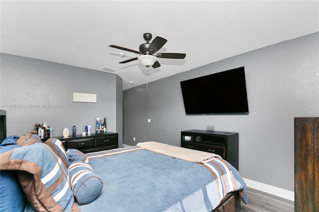 bedroom with ceiling fan and wood-type flooring