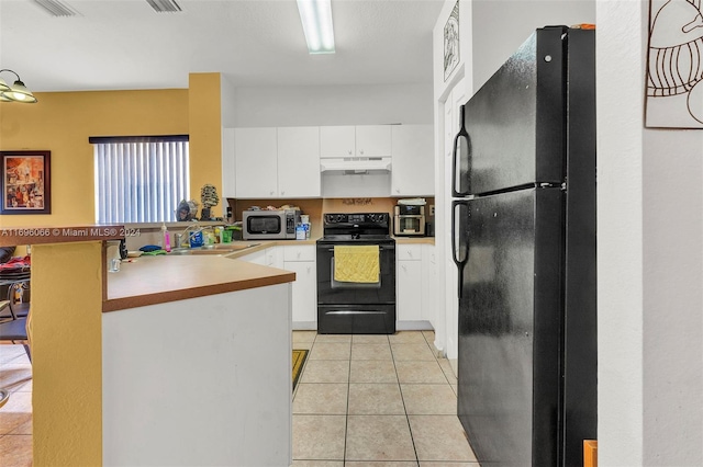 kitchen with black appliances, white cabinets, sink, light tile patterned flooring, and kitchen peninsula