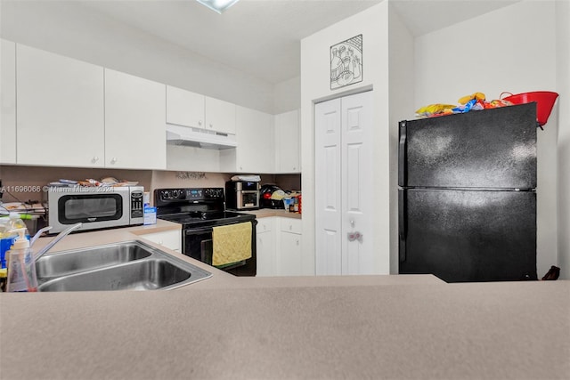 kitchen featuring black appliances, white cabinets, and sink