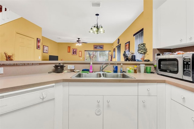 kitchen with white cabinetry, dishwasher, sink, decorative light fixtures, and ceiling fan with notable chandelier