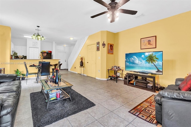 living room featuring tile patterned floors and ceiling fan with notable chandelier