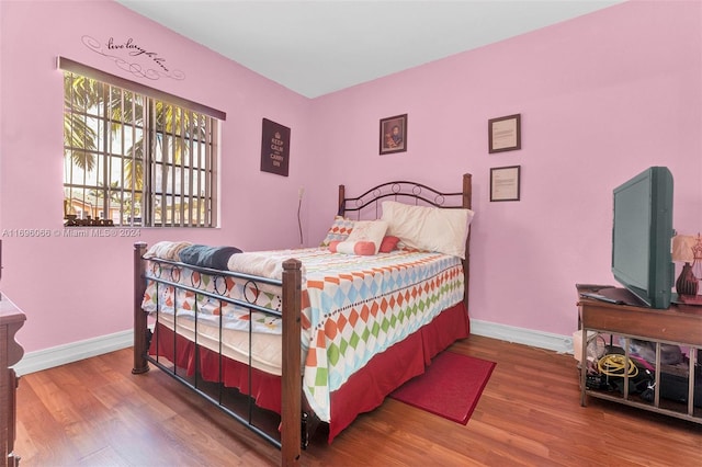 bedroom with hardwood / wood-style floors