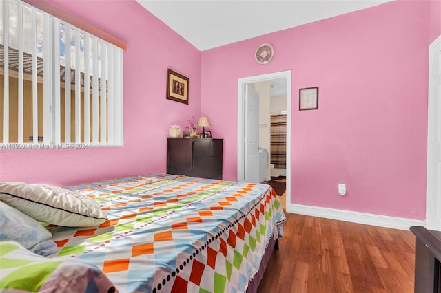 bedroom featuring hardwood / wood-style flooring and connected bathroom