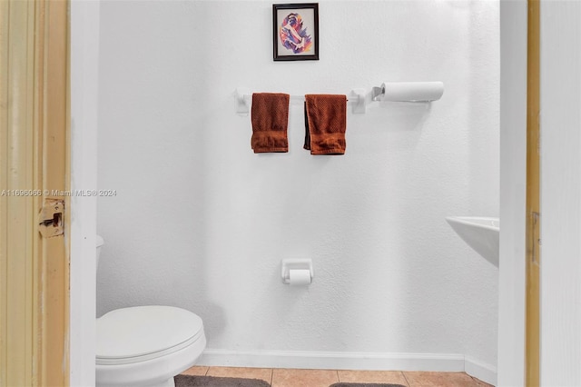 bathroom with tile patterned flooring and toilet