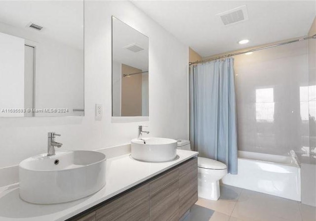 full bathroom with tile patterned floors, vanity, toilet, and shower / tub combo