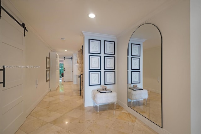 corridor featuring a barn door and crown molding