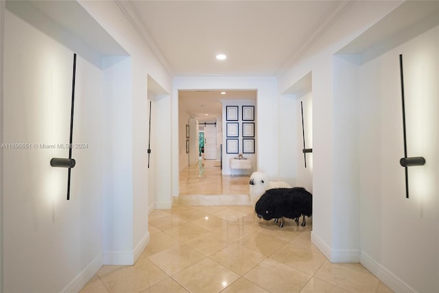 hallway featuring ornamental molding and light tile patterned flooring