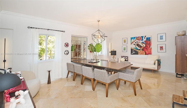 dining room with ornamental molding and a notable chandelier