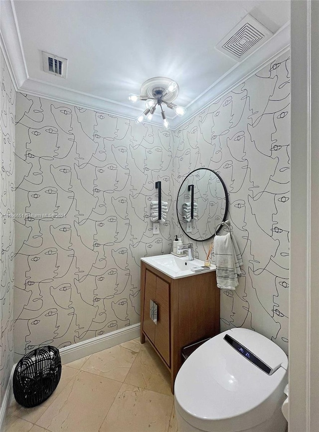 bathroom with vanity, toilet, and ornamental molding