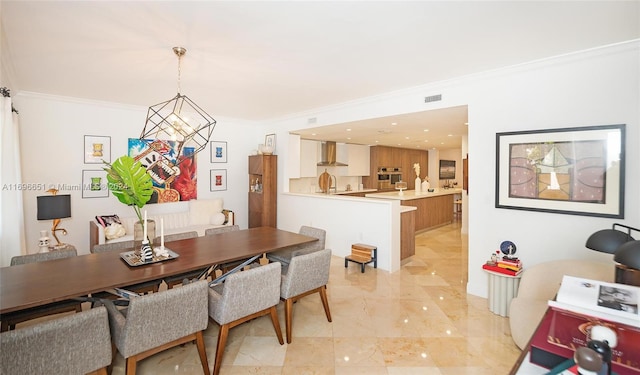 dining area featuring a chandelier and crown molding