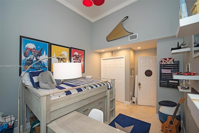 bedroom with a towering ceiling, a closet, and ornamental molding