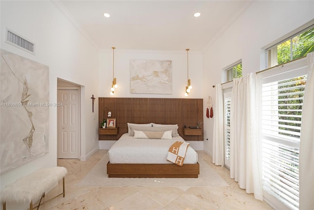 bedroom featuring a high ceiling and crown molding