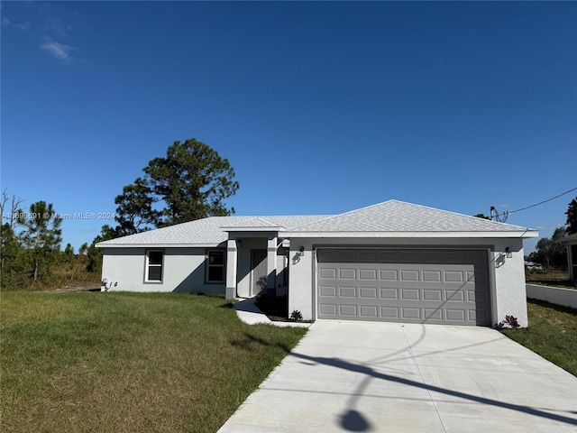 view of front of property featuring a front yard and a garage