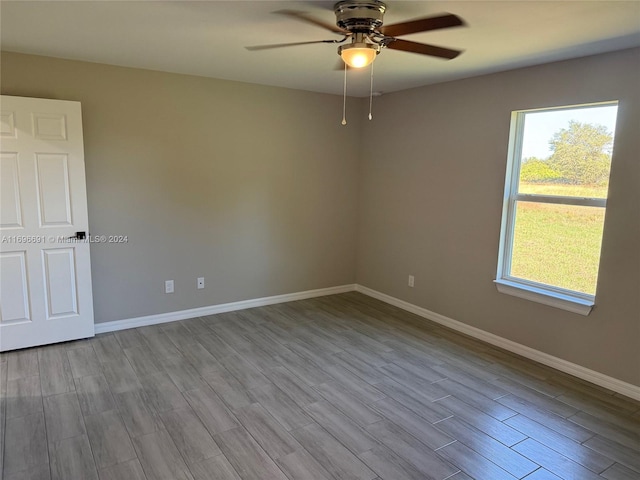 empty room with light hardwood / wood-style flooring and ceiling fan