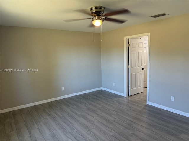 unfurnished room with ceiling fan and hardwood / wood-style flooring