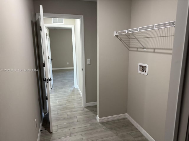 laundry area with hookup for a washing machine and light wood-type flooring