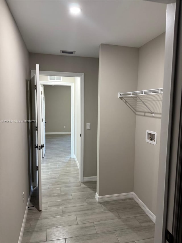 laundry area with washer hookup and light wood-type flooring