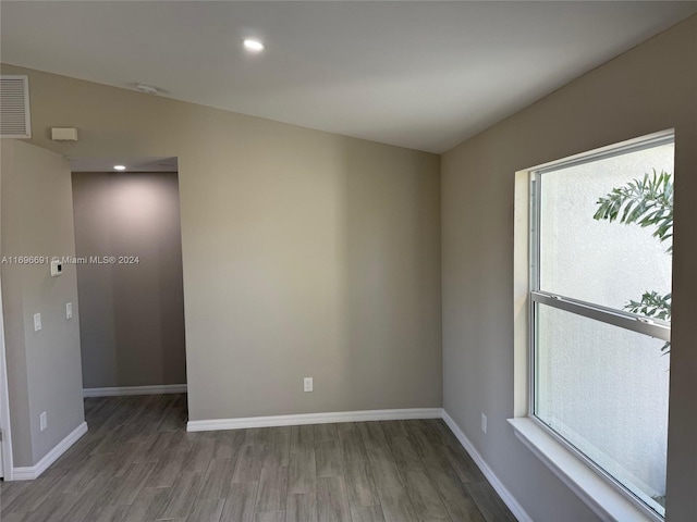 spare room with hardwood / wood-style flooring and plenty of natural light