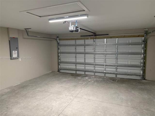 garage with electric panel and a garage door opener