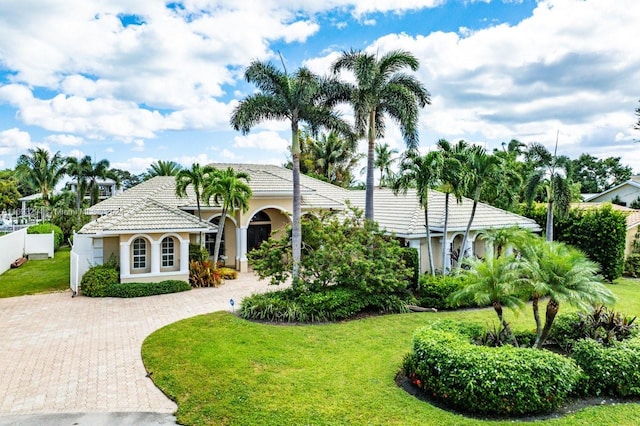 mediterranean / spanish-style home featuring a front yard