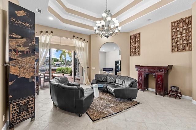 tiled living room featuring a notable chandelier, crown molding, and a tray ceiling