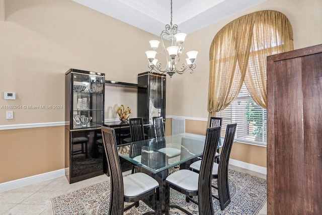 dining room featuring light tile patterned flooring and a chandelier