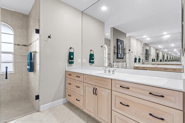 bathroom featuring tile patterned floors, vanity, and a shower with shower door