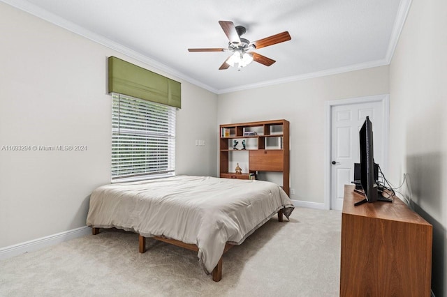 carpeted bedroom with ceiling fan and ornamental molding