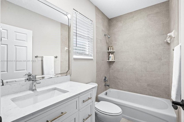 full bathroom featuring toilet, vanity, and tiled shower / bath combo