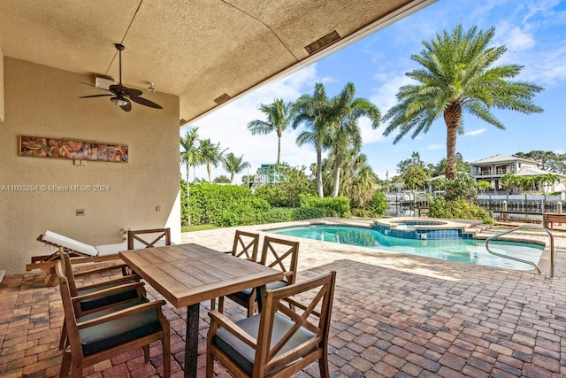 view of pool featuring a patio area, an in ground hot tub, and ceiling fan